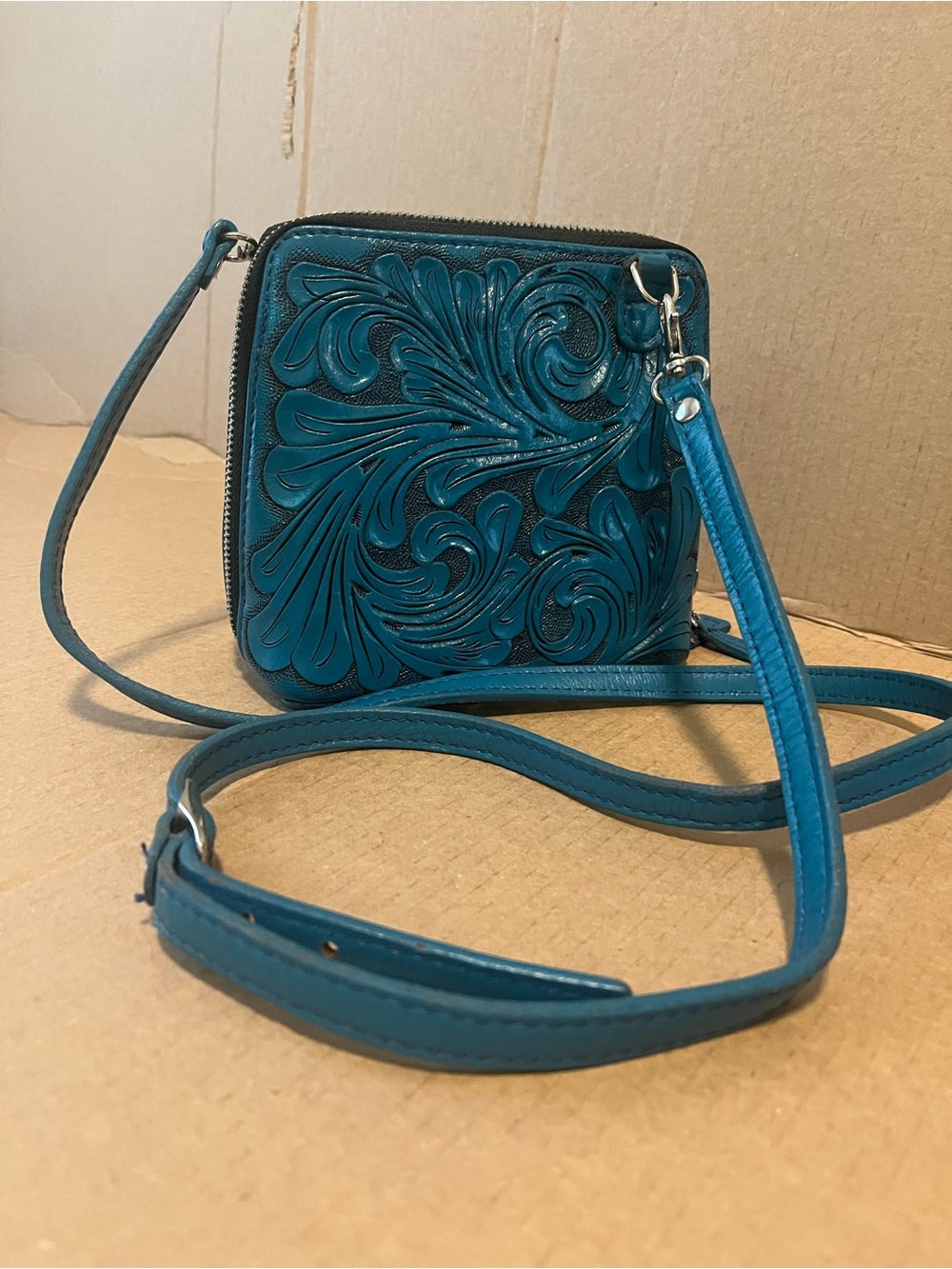 Tooled Teal Leather Crossbody Bag with Floral Motif